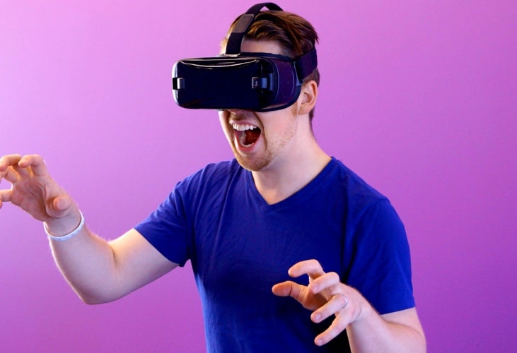 image of a guy with virtual reality glasses pretending to be a dinosaur i guess